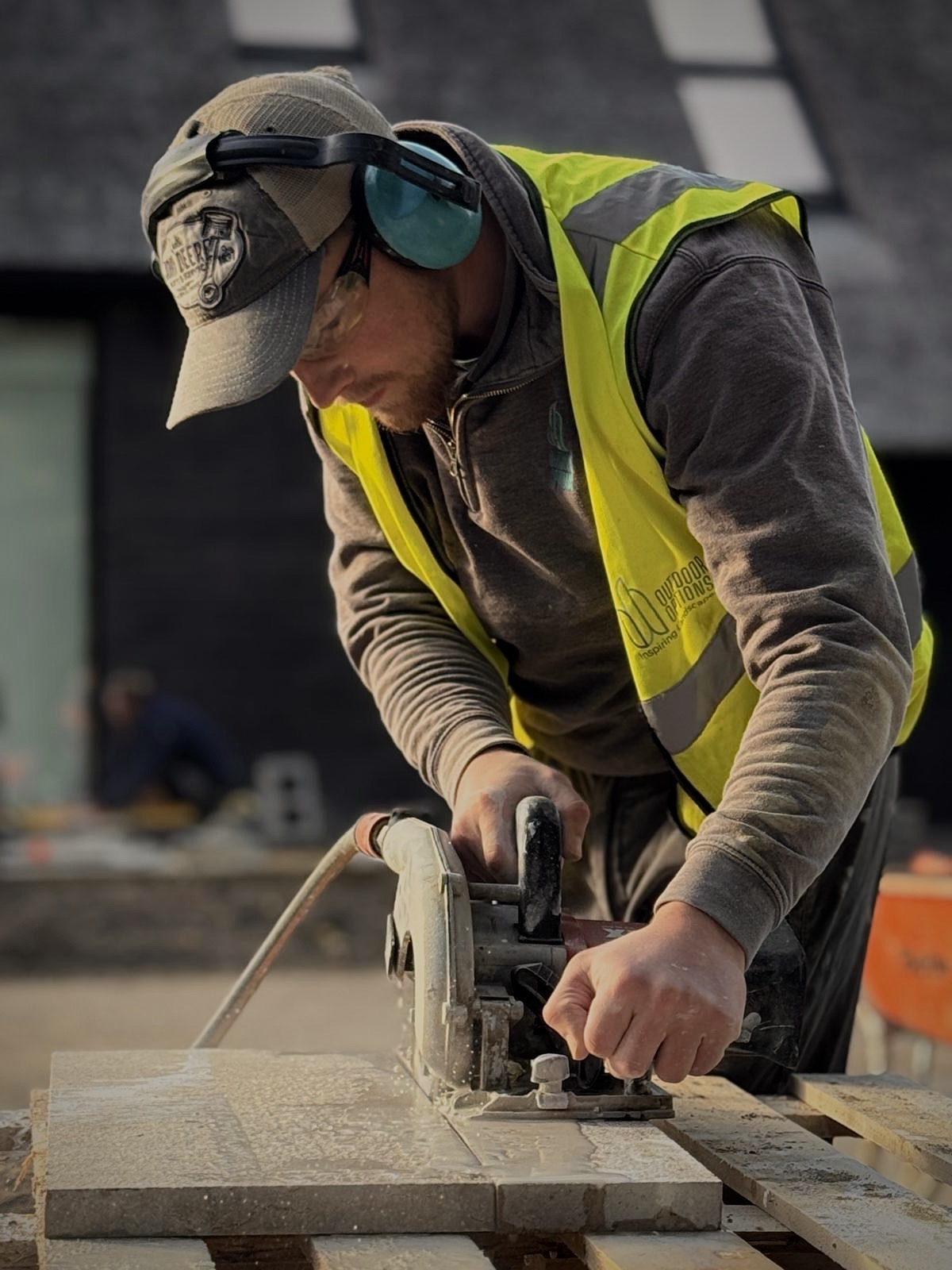 The founder of Acreline, on site, cutting paving